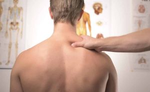 man coping with whiplash injury and back pain/ back injuries and back injuries after an auto accident