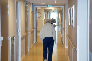 Senior woman wandering through a nursing home- wandering and elopement