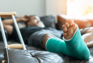 man lays in bed with broken bones after a slip and fall accident, pain and suffering after an auto accident