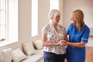 a woman and her nurse discuss the nursing home's liability insurance