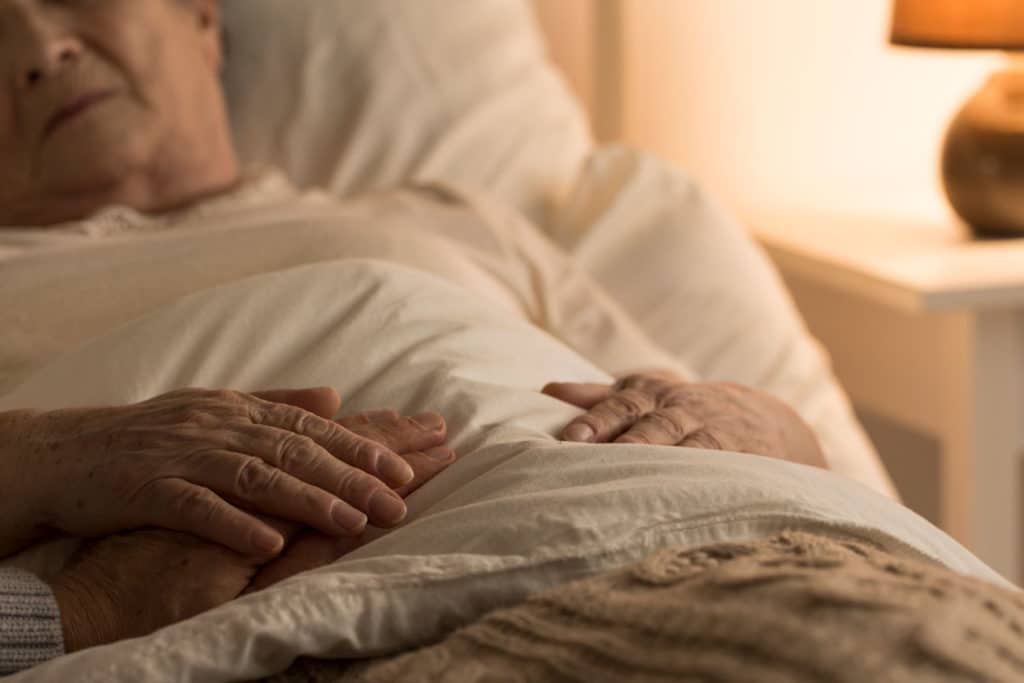 Older person laying in bed